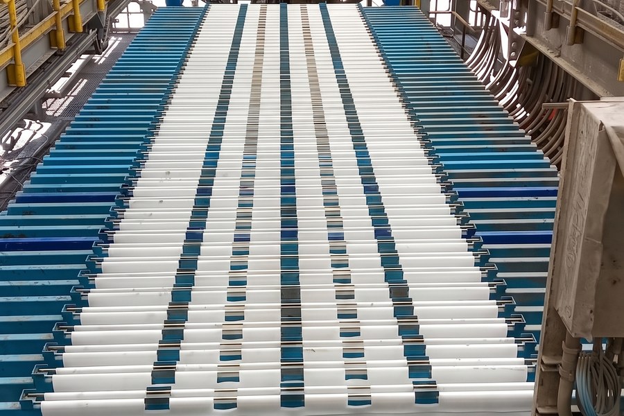 Filter press plate pack in operation inside a dewatering plant