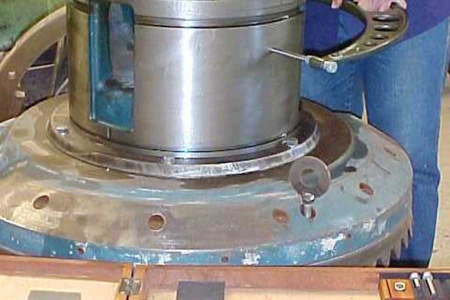 Technician fitting a bearing housing on a shop floor