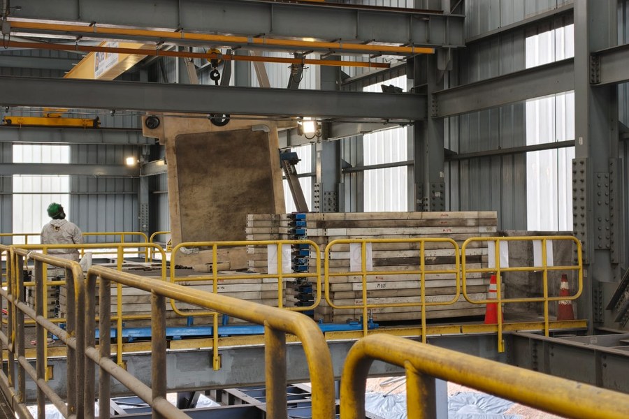 Filter press plate pack being serviced inside a dewatering plant